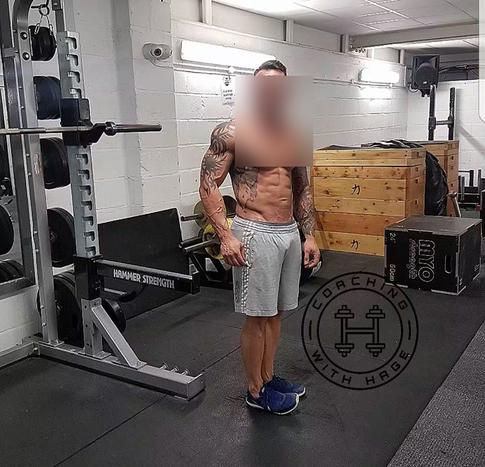 A client in peak condition after a coached training block, face blurred